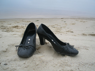 black shoes on the sand
