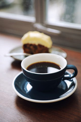 Black coffee in Coffee cup on wood background