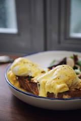 Egg benedict , poached eggs with toast on wood background , English Breakfast