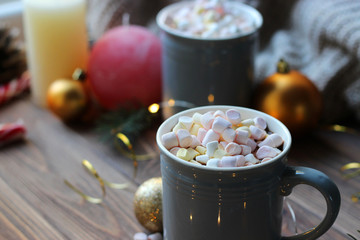  Hot cocoa, christmas accessories and garland on a wooden table. Warming drinks