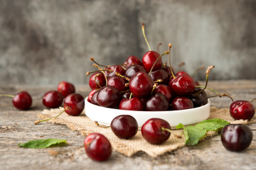 cherries in a basket on wooden table