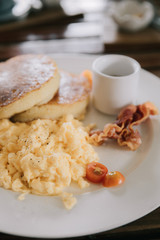 scramble egg with pancake and bacon breakfast food in film vintage style