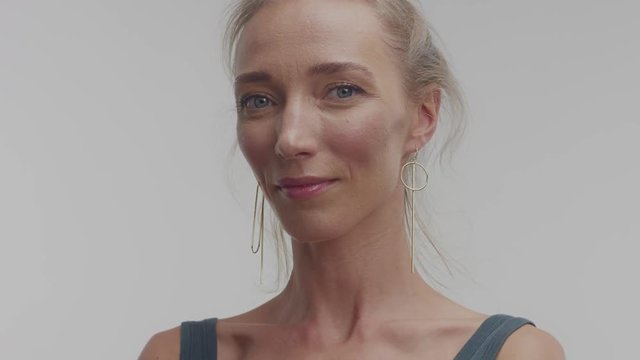 slow motion portrait of woman 30s with large moving earrings