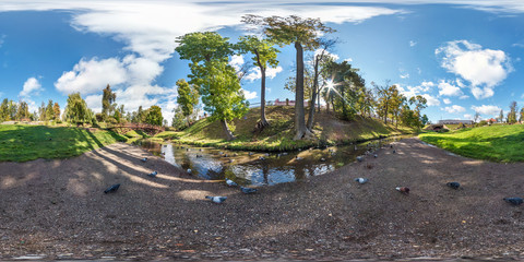full seamless spherical panorama 360 by 180 degrees angle view on the shore of small river with...