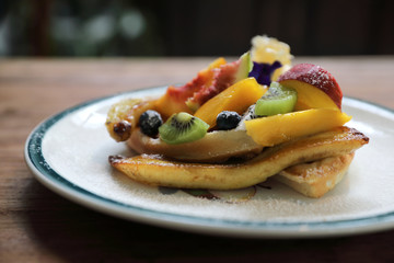Dessert baked Waffle with fruits kiwo grape berry and vanilla ice cream vintage style