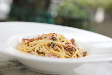 Spaghetti carbonara , Spaghetti white sauce with cheese bacon in outdoor restaurant italian food