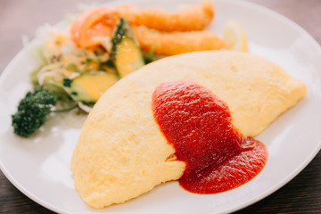 fried rice omelette on top and shrimp tempura japanese food style