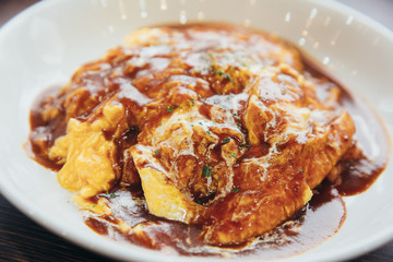 Curry rice with omelet Japanese style on wood background film vintage style