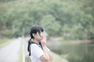 Portrait of asian japanese school girl costume looking at park outdoor film vintage style