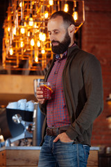 businessman male brunette beard glass hold cafe office house loft brave bearded hipster mulled wine