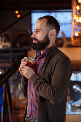 businessman male brunette beard glass hold cafe office house loft brave bearded hipster mulled wine