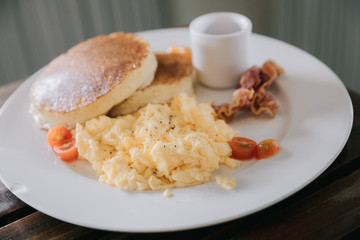 scramble egg with pancake and bacon breakfast food in film vintage style