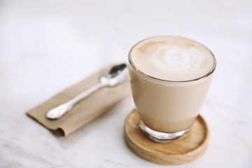 cappuccino or Latte art coffee made from milk on the wood table in coffee shop