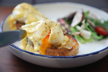 Egg benedict , poached eggs with toast on wood background , English Breakfast