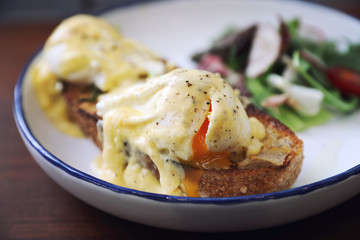Egg benedict , poached eggs with toast on wood background , English Breakfast