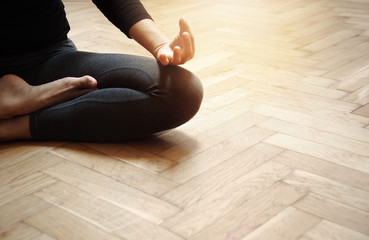 adult woman in yoga meditation relaxation post sport on the old wood floor