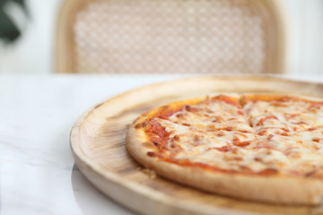 pizza margarita on wood dish in coffee shop background