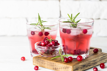 Cocktail with cranberry, vodka, rosemary and ice.