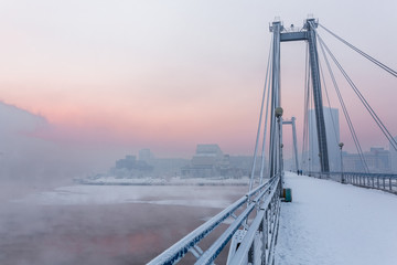 Cable-stayed bridge across the Yenisei river in the winter morning. Krasnoyarsk, Krasnoyarsk Krai, Russia.