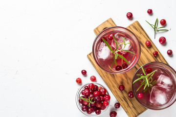 Cocktail with cranberry, vodka, rosemary and ice.