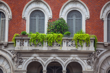 houses with flowers on the windows in Milan, Italy