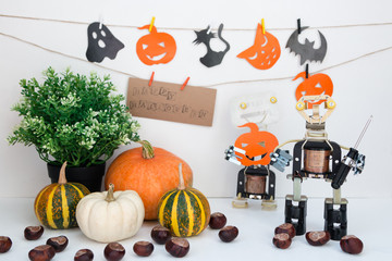 Happy halloween at STEM education school. Flat lay. Metal Robot and pumpkin all around. Free spase for text.