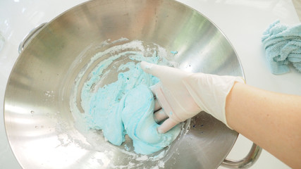 Chef hand thresh the sticky rice flour and tapioca starch are mixed soft blue color in stainless pan