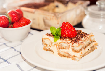 Tiramisu - Classical Dessert Garnished with Strawberry and Mint