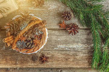 Christmas New Year composition with gift box fir branch basket pine cones on old shabby rustic wooden background. Xmas holiday december decoration to Russian tradition. Flat lay, copy space