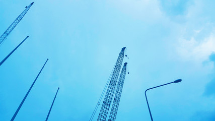 The construction crane on blue sky background, beautiful view landscape, wallpaper design