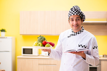 Young professional cook preparing salad at home