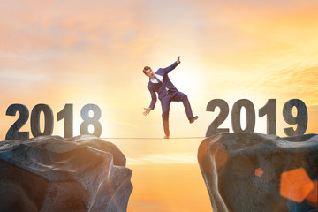 Businessman balancing between 2018 and 2018