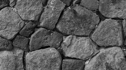 Black and white background wich basalt stone wall