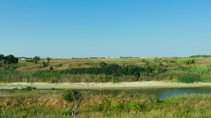 Sunny summer landscape with river.Green meadows.