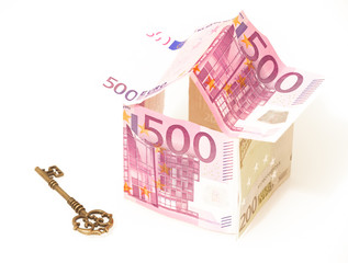 euro, the symbol of a housing loan. European money in the shape of a house and a key on a white background.
