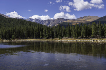 Naklejka premium A fall view of a calm alpine lake with Mt. Evans in the background.