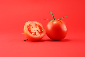 tomato on red background. italian healthy vegan food concept with tomatoes.