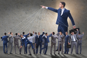 Boss employee manipulating his staff in business concept