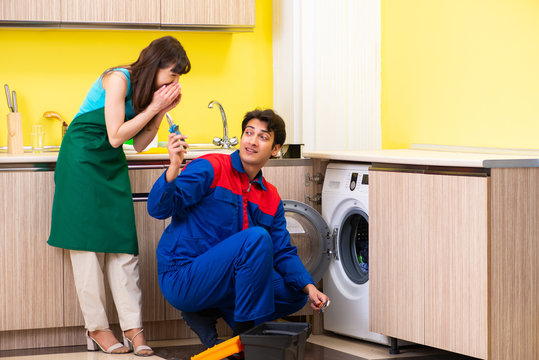 Contractor repairing washing machine at home