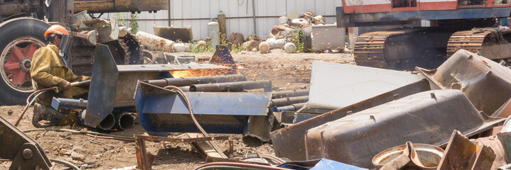 Welder in junk yard