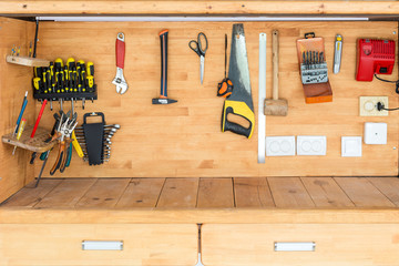 Wooden workbench at workshop. Lot of different tools for diy and repair works. Wood desk for...