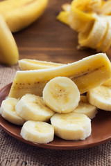 Sliced ripe banana in a round plate.