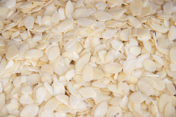 Sliced almonds flakes as light white background