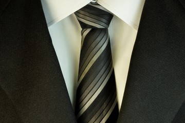 Tie and white shirt and suit, in the wardrobe of men used as decoration, accessory, part of business clothing. Wear to a wedding, prom or graduation.