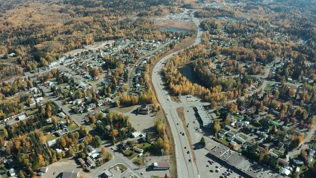 A cinematic, panning, aerial view of a small city during the autumn season. Also known as the "Hart".