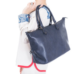  woman with blue handbag in hands. Isolated white background.