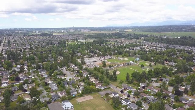 Suburban Area of Cloverdale, Surrey, BC, Canada Filmed with Aerial 4k Drone. Baseball Field Can be Seen Surrounded by Many Trees, Homes and Streets