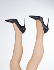 woman with legs up and stiletto female shoes with high thin heels