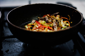 cooking ovoci and meat in a skillet