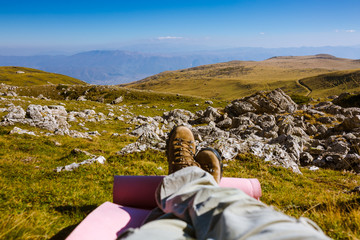 Woman with legs crossed enjoying her view in the mountains